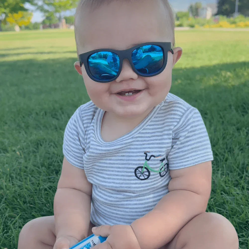 Baby wearing bicycle organic onesie and sunglasses