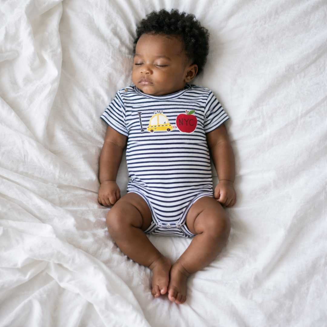 Baby bodysuit on sleeping newborn