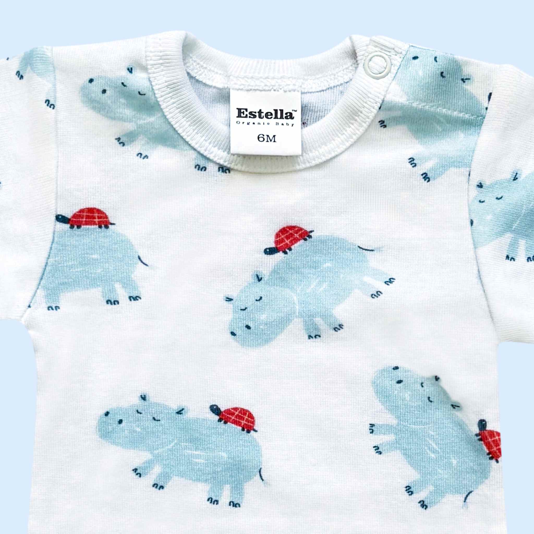 Estella Baby Clothes Organic Onesie with Blue Hippo and Turtle Print. Detail showing the neckline and snap closure