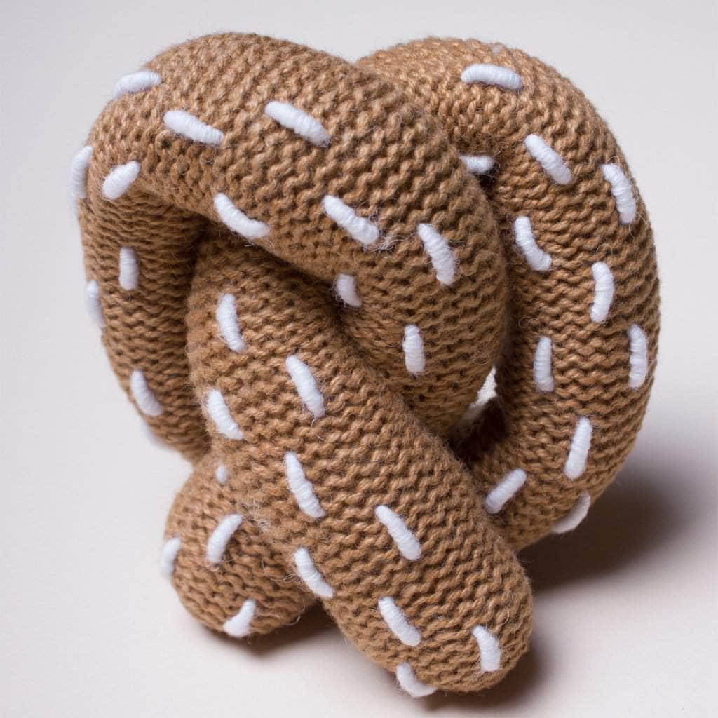 organic baby pretzel baby rattle toy. Brown and white dots.