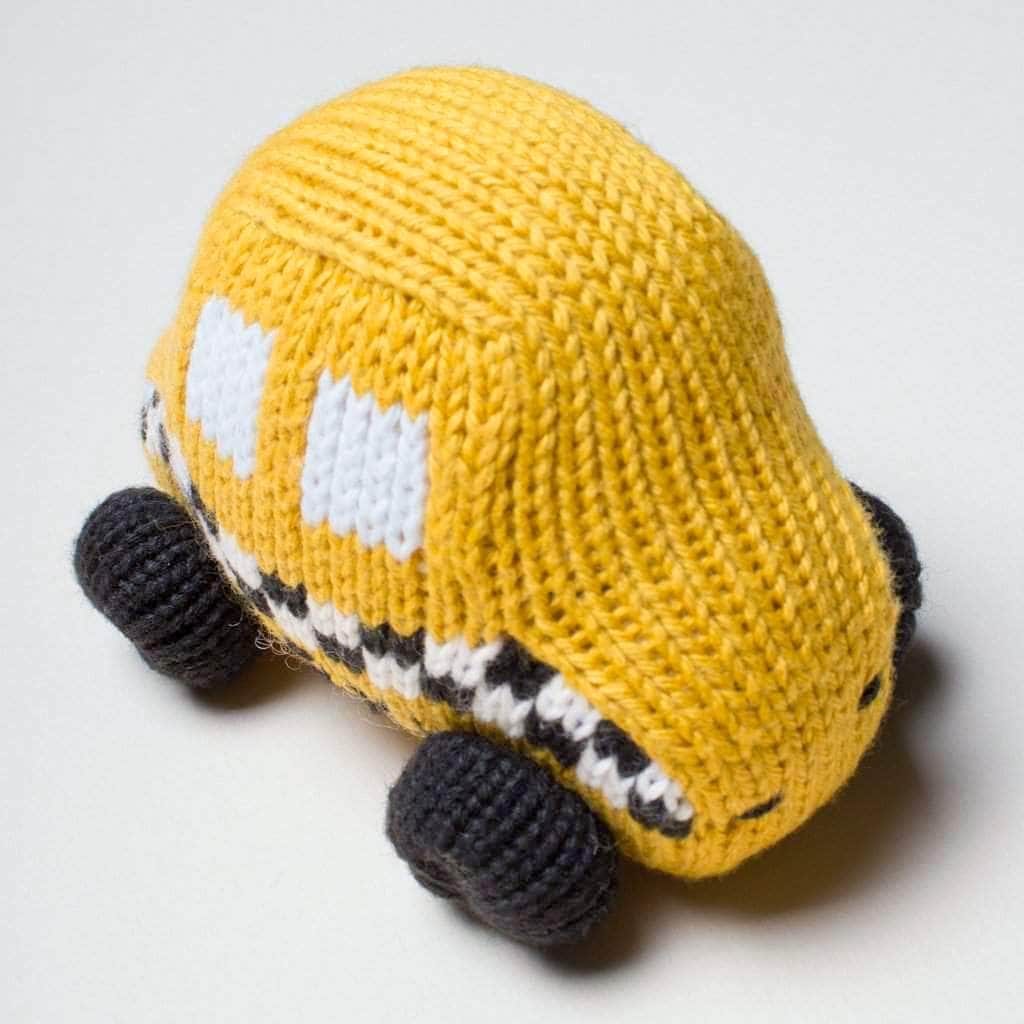 organic baby rattle taxi toy. Black, white, and yellow. 