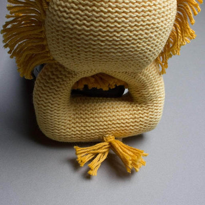 back of rattle toy organic lion. yellow and gold.