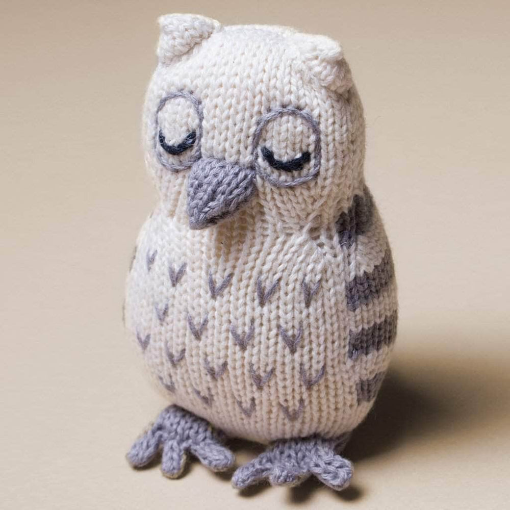 Owl baby toy made with organic cotton. This rattle is handknit in cream with grey details and black hand stitched eyes.