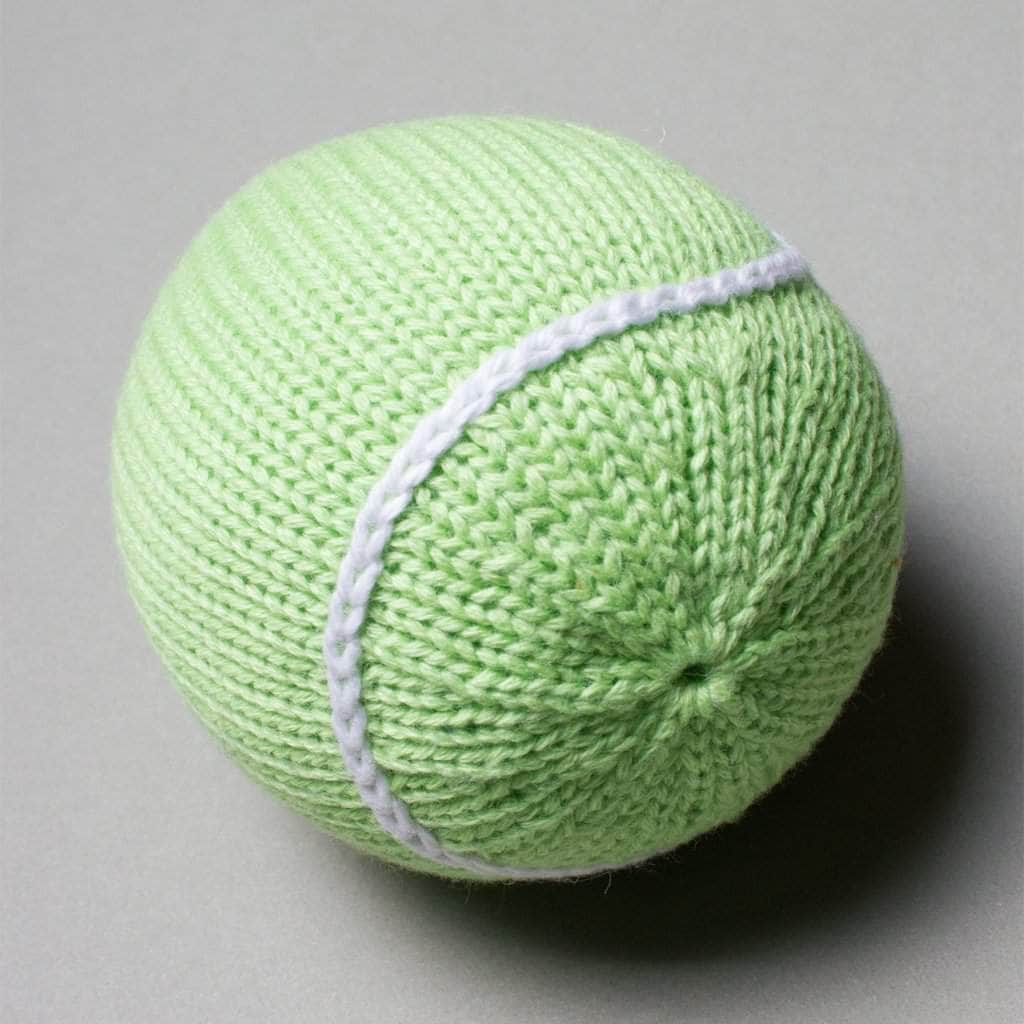 Estella Organic Baby Tennis Ball Rattle Toy on Blue Background