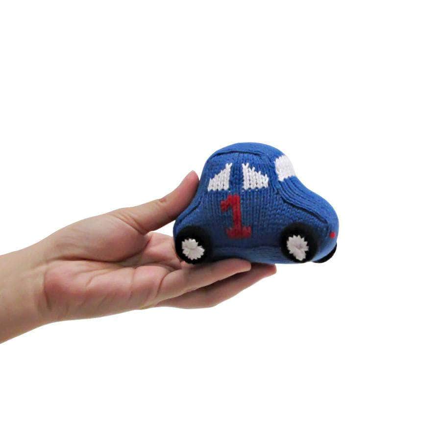 Organic race car rattle baby toy in blue, white & red photographed in a hand showing that it is about 4 inches wide.