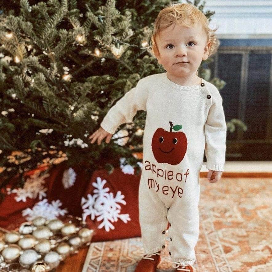 Holiday Gift Guide for Baby's First Christmas - Baby Wearing Romper, 'apple of my eye' near Xmas Tree