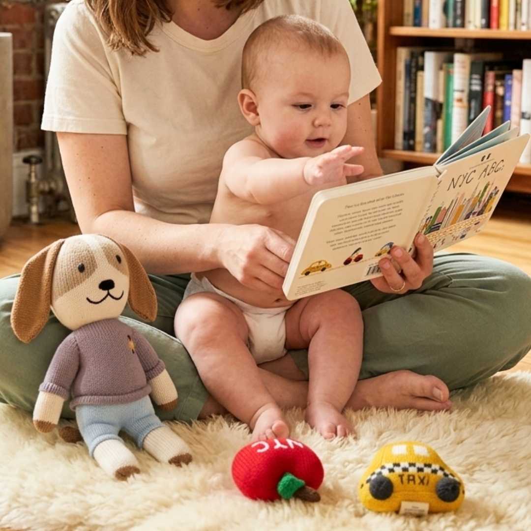 Mom reading with baby with organic toys in background.