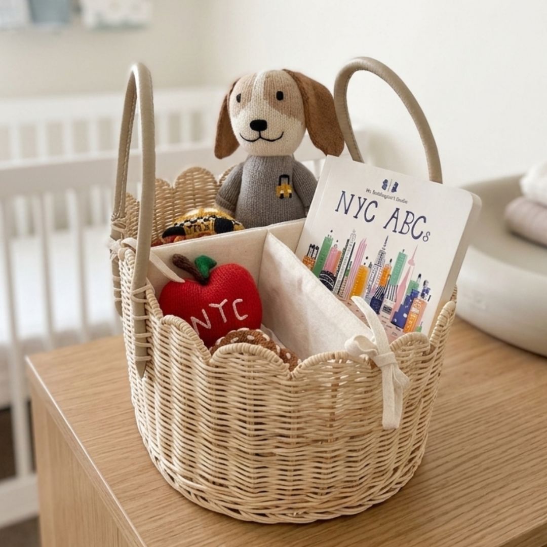 Gender-neutral baby gift basket with organic cotton bodysuits, knit dog doll and rattles | Estella