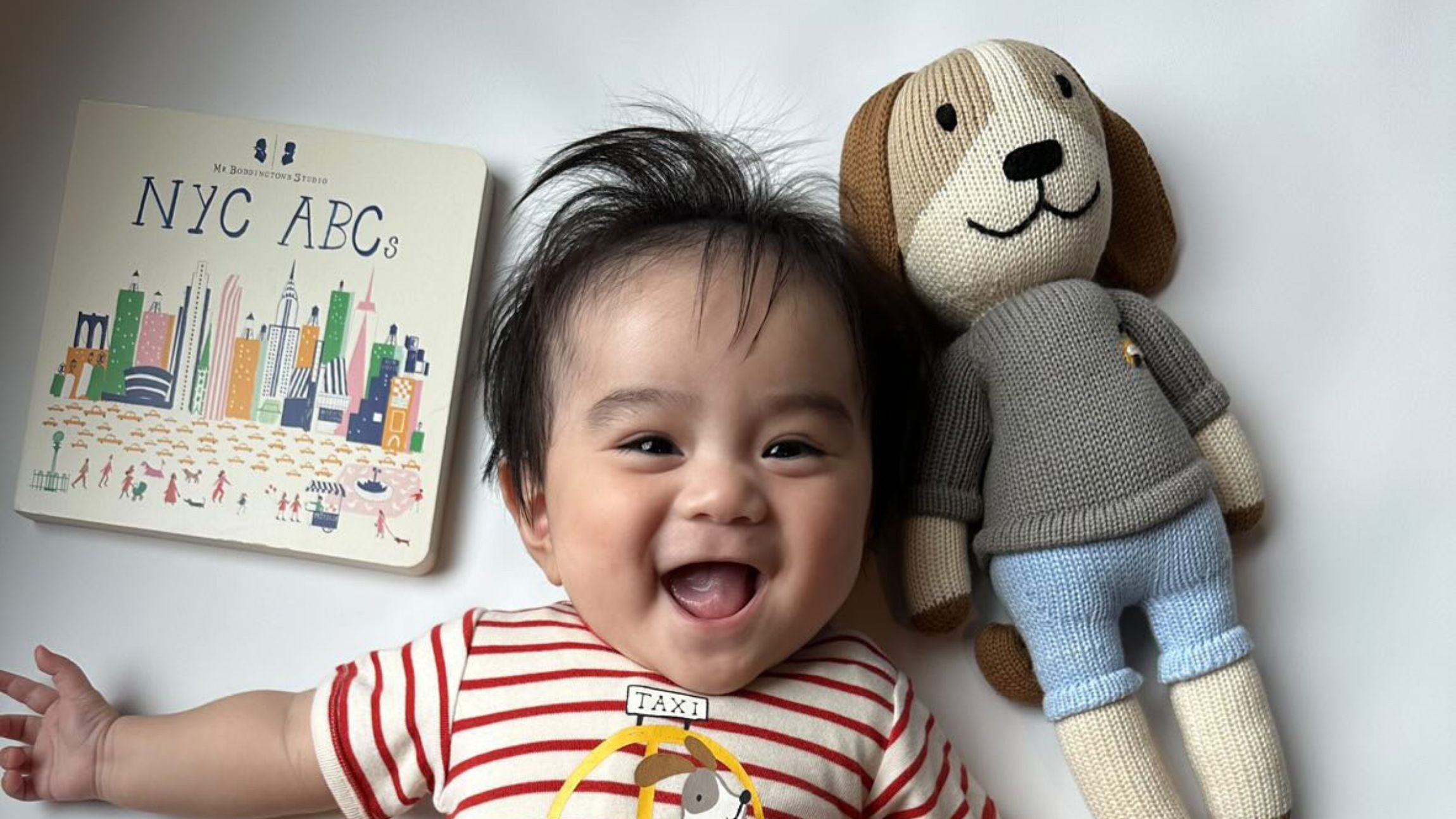 Smiling child with dog doll toy