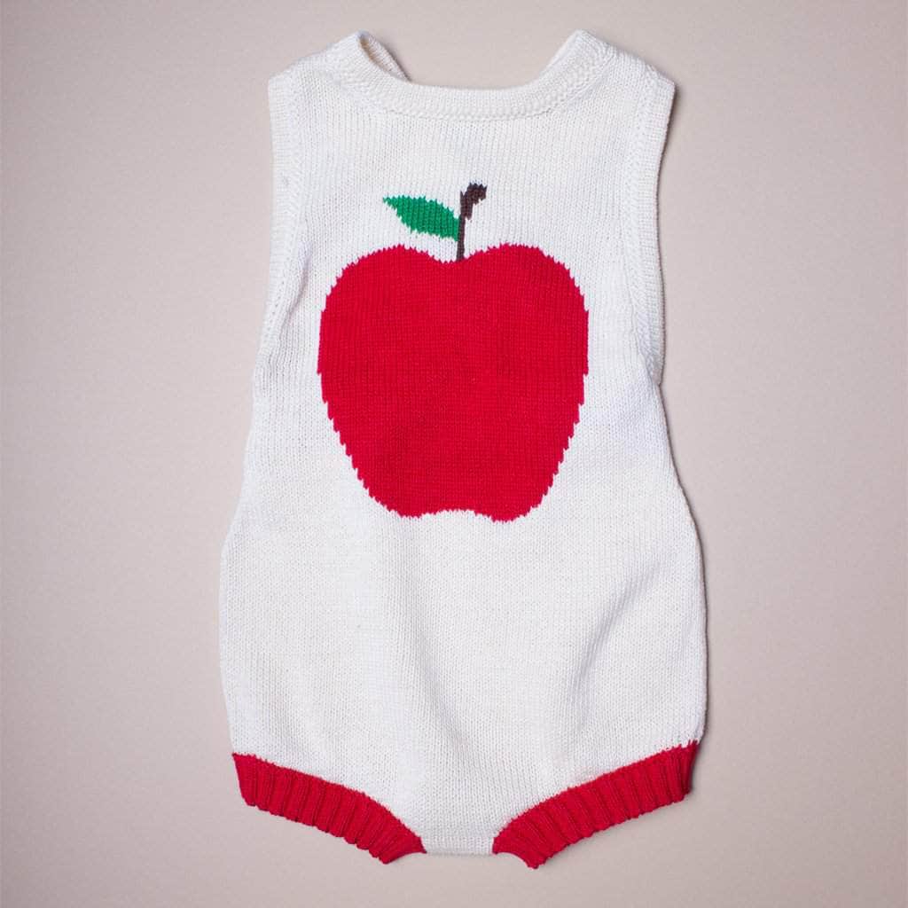 organic sleeveless romper with apple graphic in the front. Red, green, and cream.