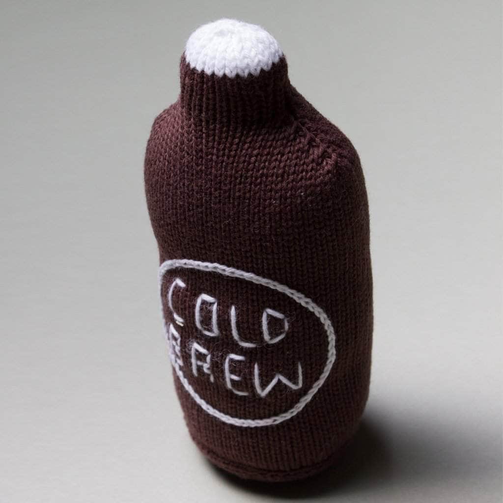 cold brew coffee baby rattle toy. brown, white and white letters.