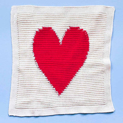 Organic heart blanky with cream, ribbed background and large, red heart.