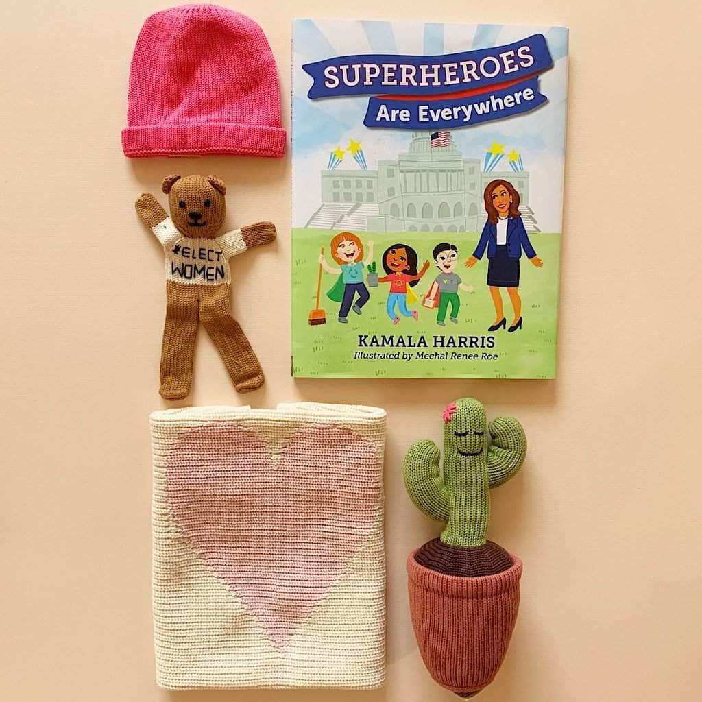 organic future is her gift set. pink hat, bear comforter with elect women, Superheroes are Everywhere book, pink heart blanket, cactus stuff toy. 