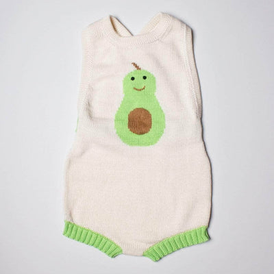 Knit baby romper with an intarsia of a smiling avocado in the chest.  The romper is cream with green trim on the thighs.