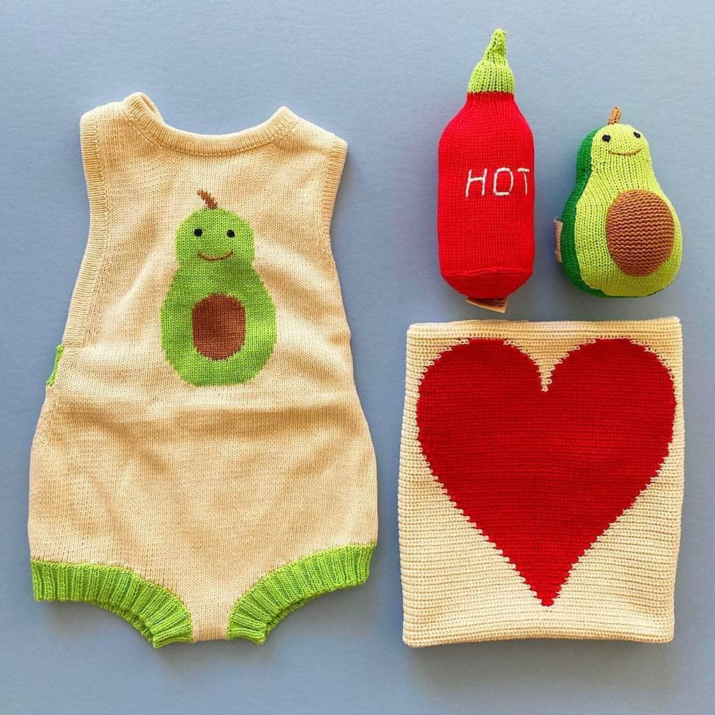 luxury baby gift set with a red heart 14" sq security blanket, a "hot" sauce rattle toy, an avocado shaped rattle & a newborn sleeveless knit romper wit an intarsia of the romper.