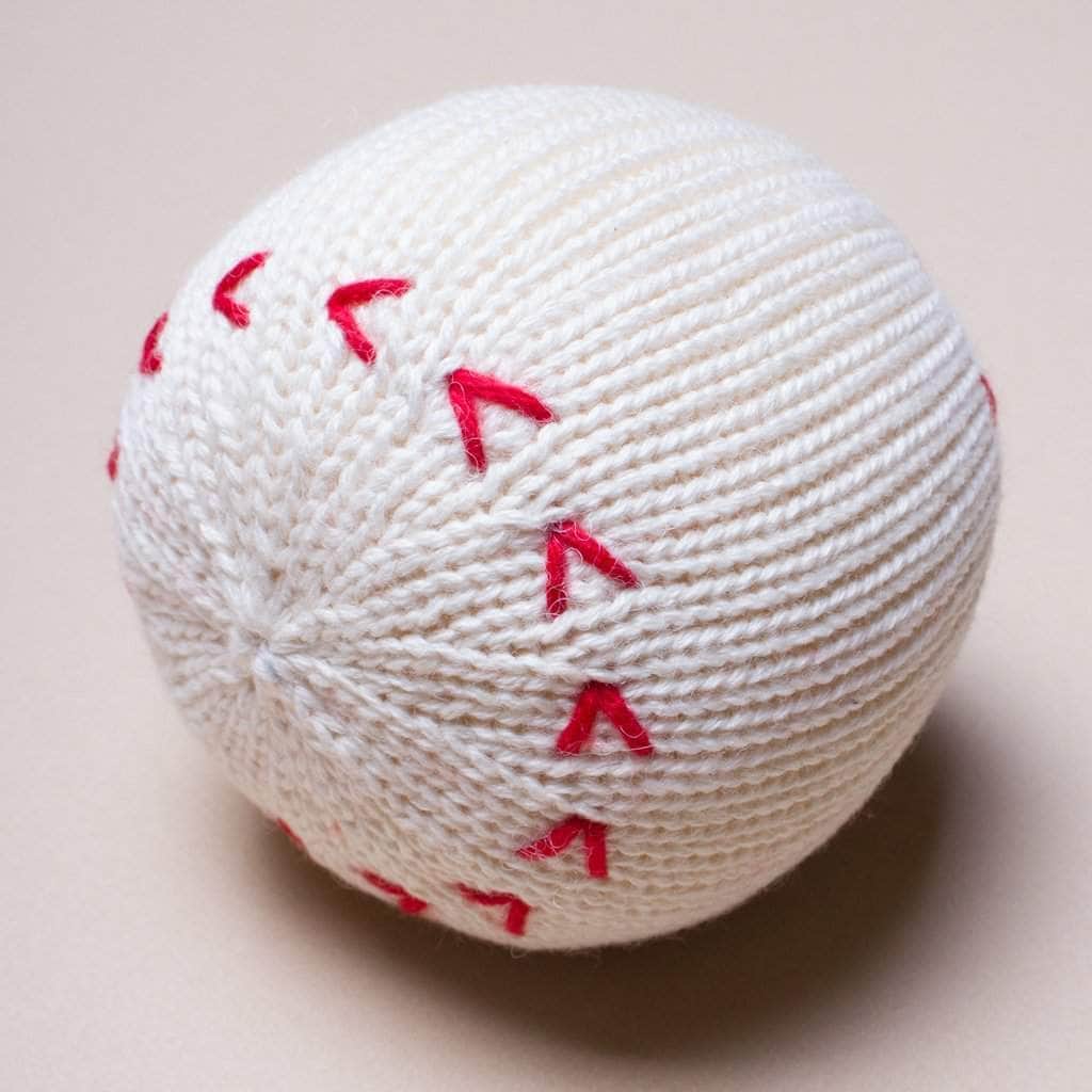 organic baby rattle baseball toy. White with red stitches. 