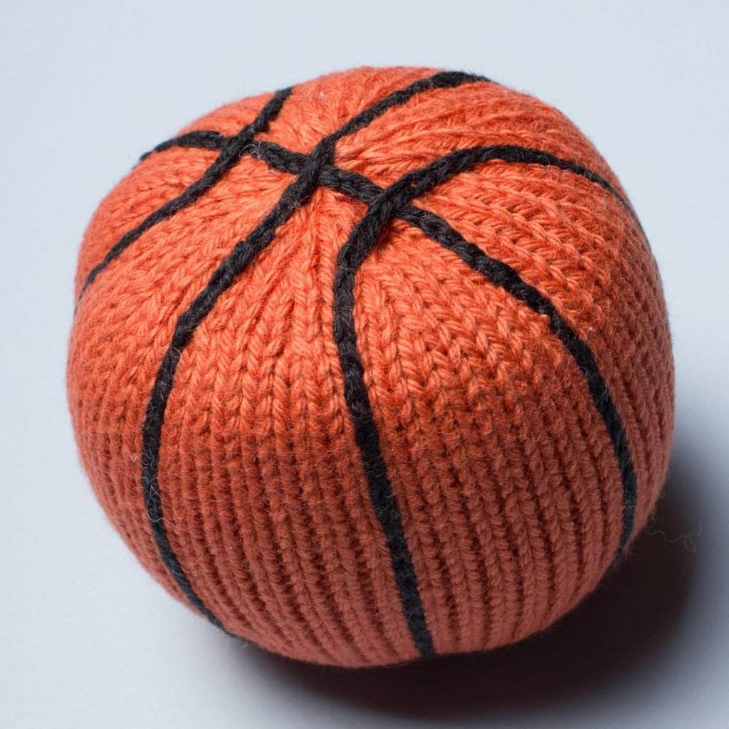 organic baby rattle toy basketball. Orange with black stitches.
