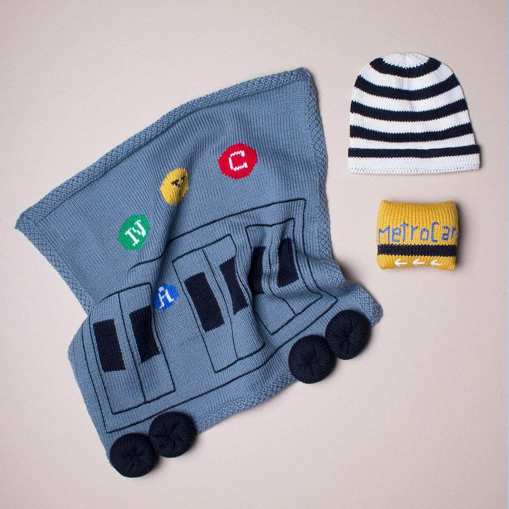 organic baby gift set. Metro subway train blanket, metro card rattle, and black stripes hat.