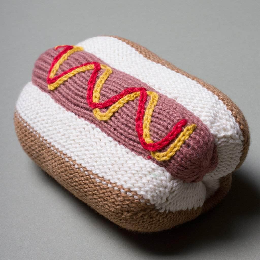 organic baby rattle hot dog toy knit. brown, red, yellow, pink and cream.