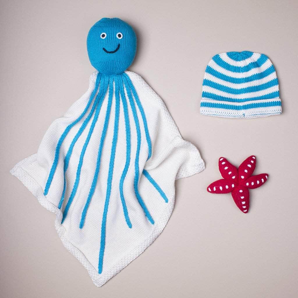 organic octopus blank baby gift set. Octopus blanket, red starfsih, and blue stripes hat.