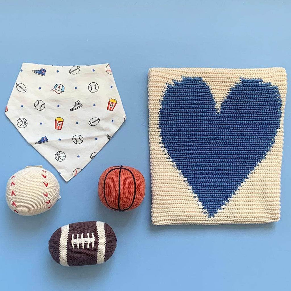 organic baby gift set. sport print bib, blue heart blanket, baseball rattle, basketball rattle, and football rattle.