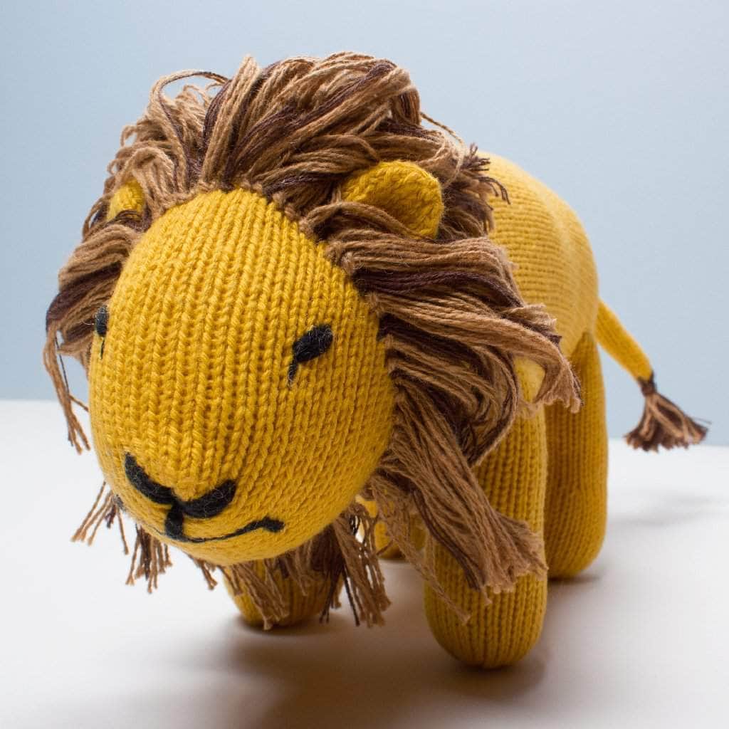 Lion stuffed animal - organic baby toy knitted in yellow with black details. Photo shows face with mane.