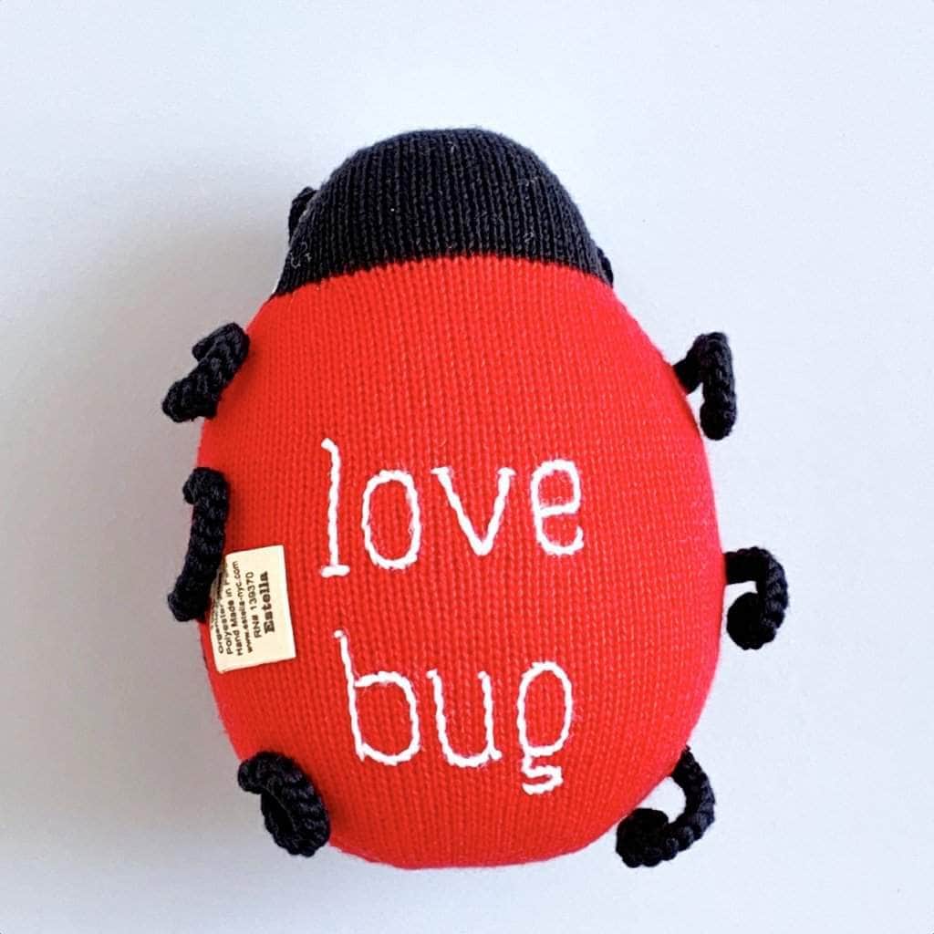 bottom photo of organic ladybug stuff toy. Red, black ,and white letter.