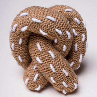 organic baby rattle pretzel toy. brown and white stitches as salt.