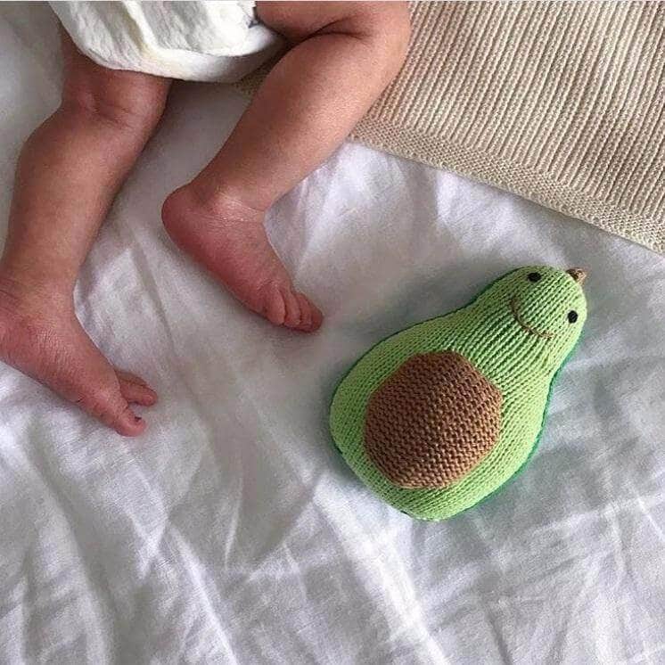 Baby Rattle - Knit Avocado Shaped Rattle with Smiling Face on Bed near sleeping baby