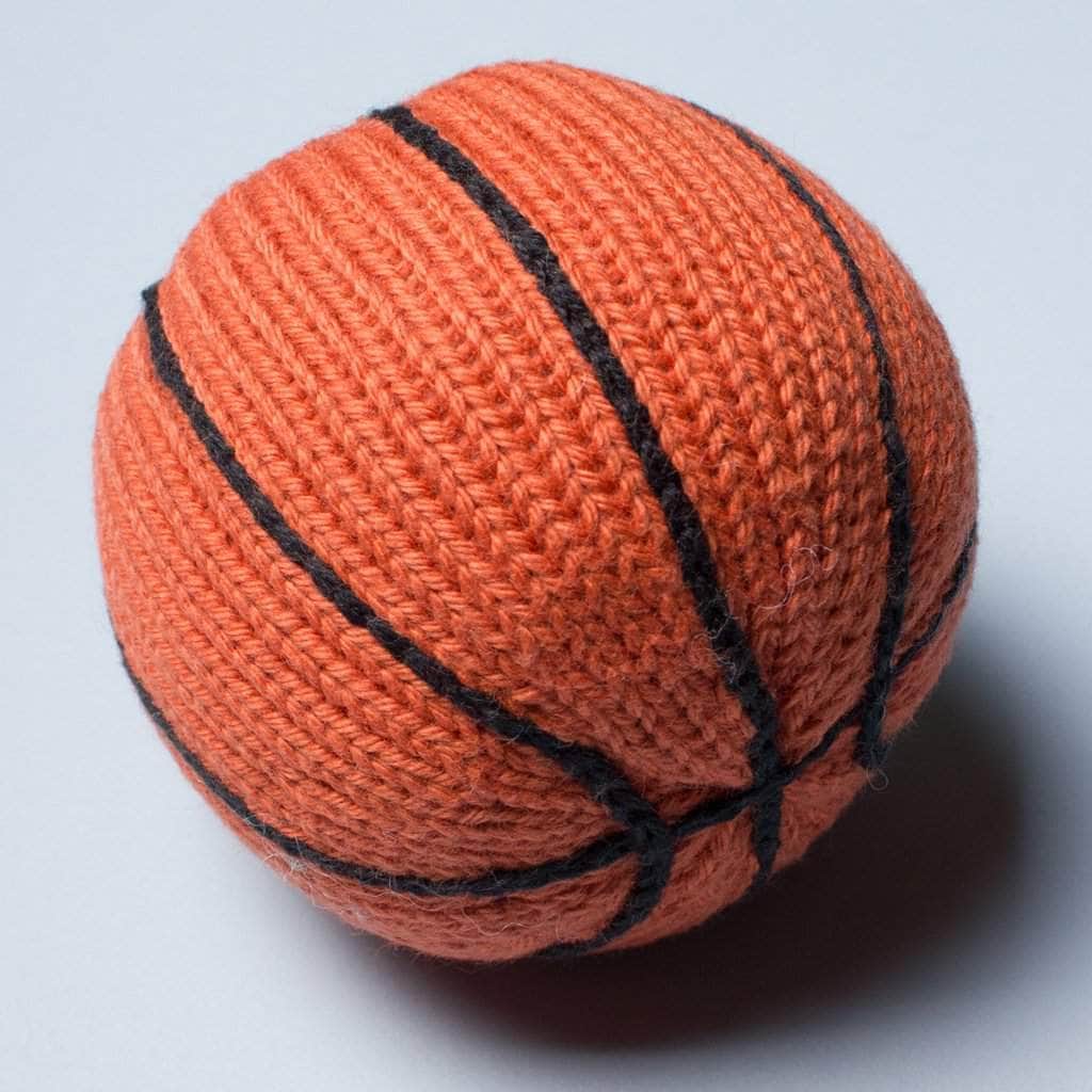 organic knit baby rattle basketball toy. Orange and with black stitches. 