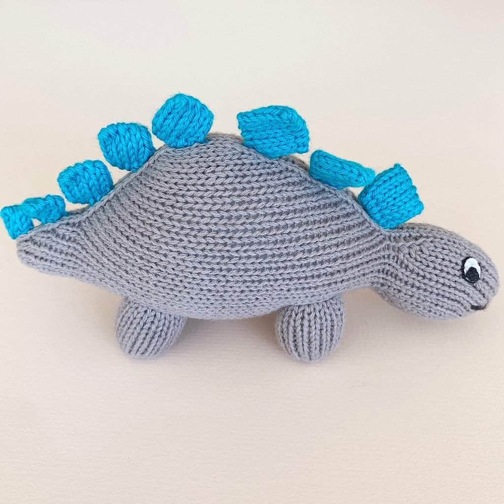 organic baby rattle toy stegosaurus. Grey and blue with white eyes.