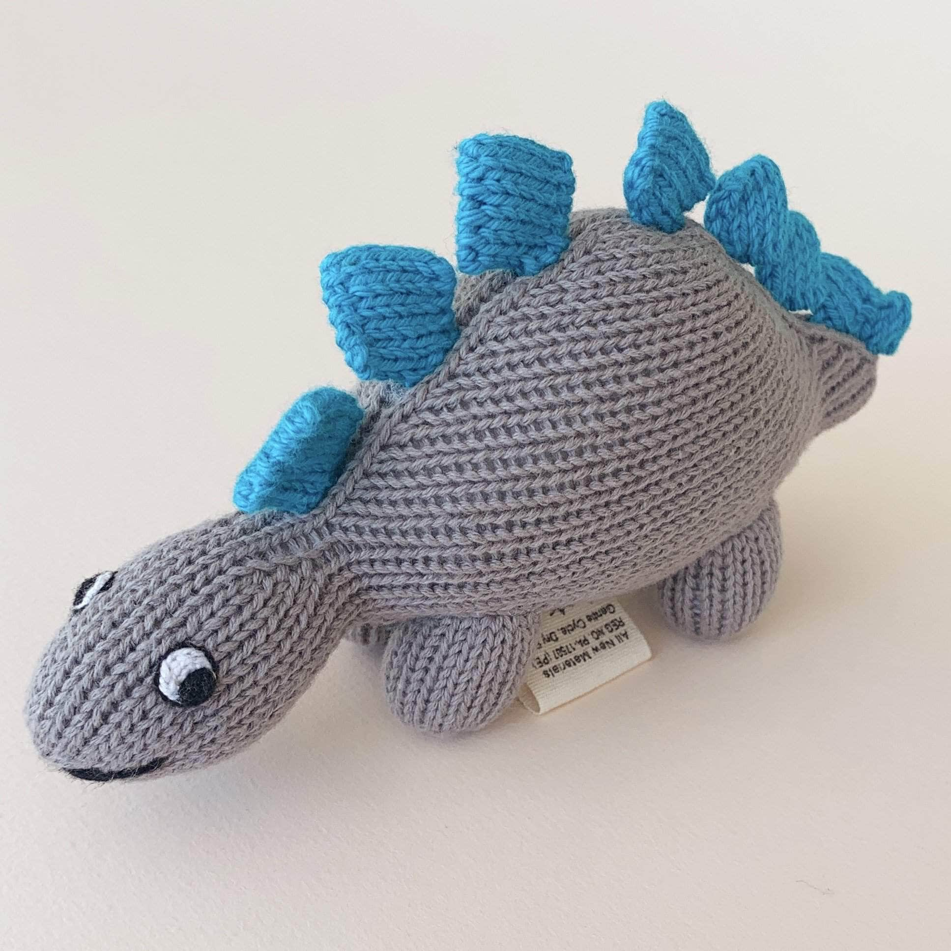 organic baby rattle toys Stegosaurus. Grey and blue with white eyes.