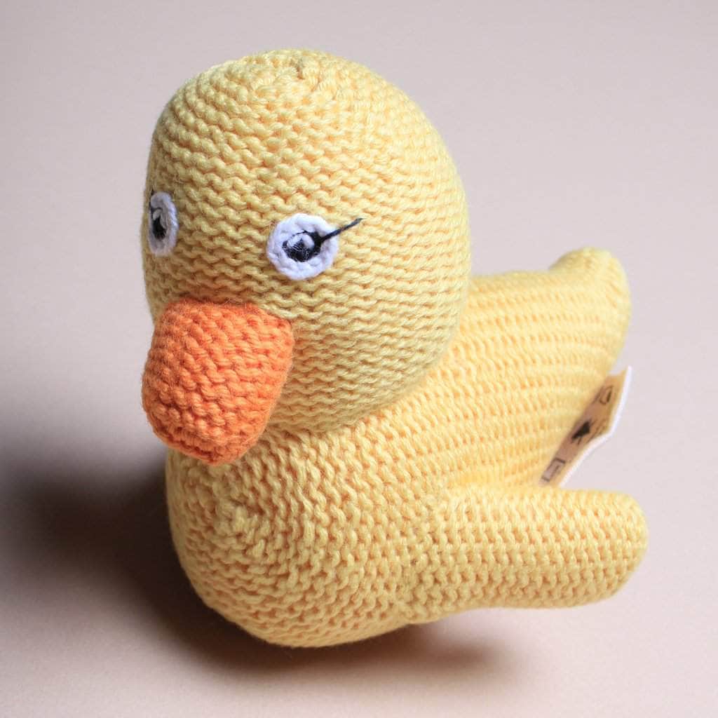 Organic baby rattle duck toy. Yellow, orange, and white eyes.
