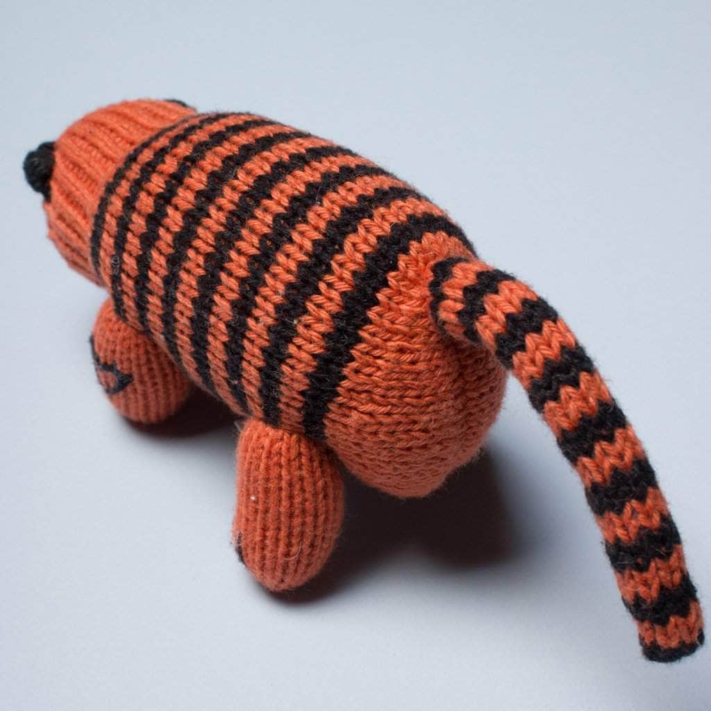 back of organic rattle toy tiger. Orange and black.