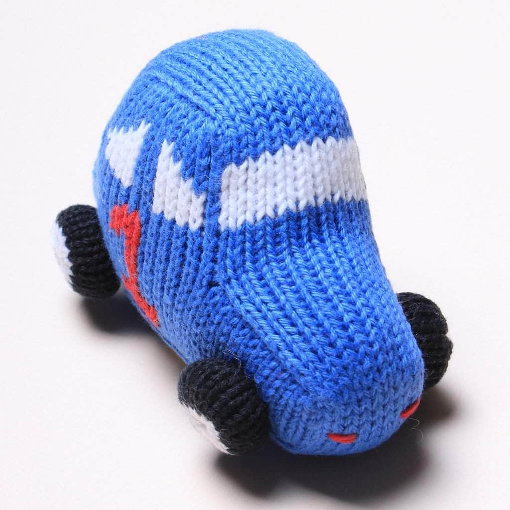 Race car toy rattle.  This organic infant toy is knitted in Peru with hand stitched details. Body is blue with red #1 and white windows.
